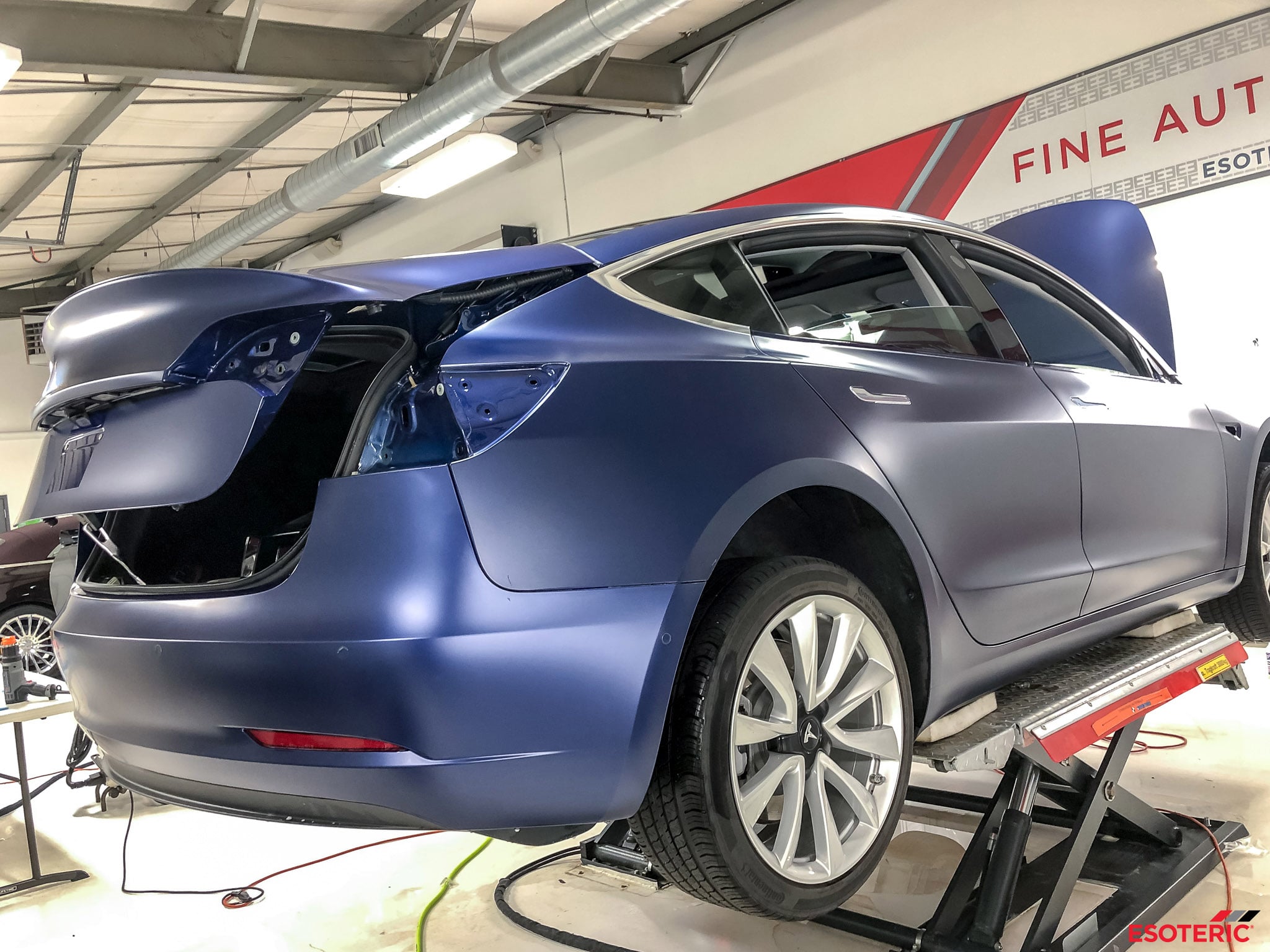 Tesla car being detailed at a car repair shop.